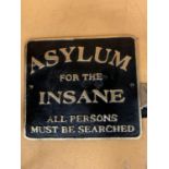 A BLACK CAST IRON SIGN WITH GOLD COLOURED LETTERING "ASYLUM FOR THE INSANE"