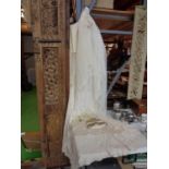 A VINTAGE SATIN WEDDING GOWN, A SILK FRINGED WEDDING SHAWL, TWO LACE VEILS, A VINTAGE BEADED BAG AND