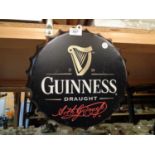 A TIN METAL 'GUINESS' BOTTLE TOP SIGN