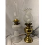 TWO OIL LAMPS, ONE WITH A WHITE GLASS BASE AND THE OTHER A BRASS EXAMPLE