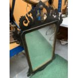 A LARGE MAHOGANY FRAMED MIRROR WITH CARVED DETAIL AND FLEUR DE LIS DECORATION