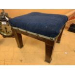 A SMALL FOUR LEGGED BLUE UPHOLSTERED FOOTSTOOL