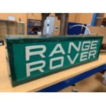 AN ILLUMINATED 'RANGE ROVER' SIGN