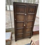 AN OAK 'D.M.ETCHWORTH' TWO DOOR WARDROBE WITH LINEN FOLD PANELS