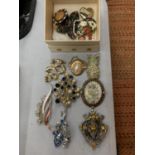 A SMALL BOX OF COSTUME BROOCHES