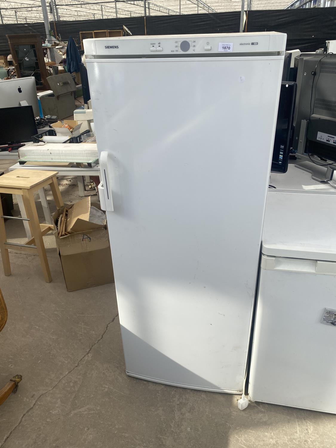 A WHITE SIEMENS UPRIGHT FREEZER BELIEVED IN WORKING ORDER BUT NO WARRANTY