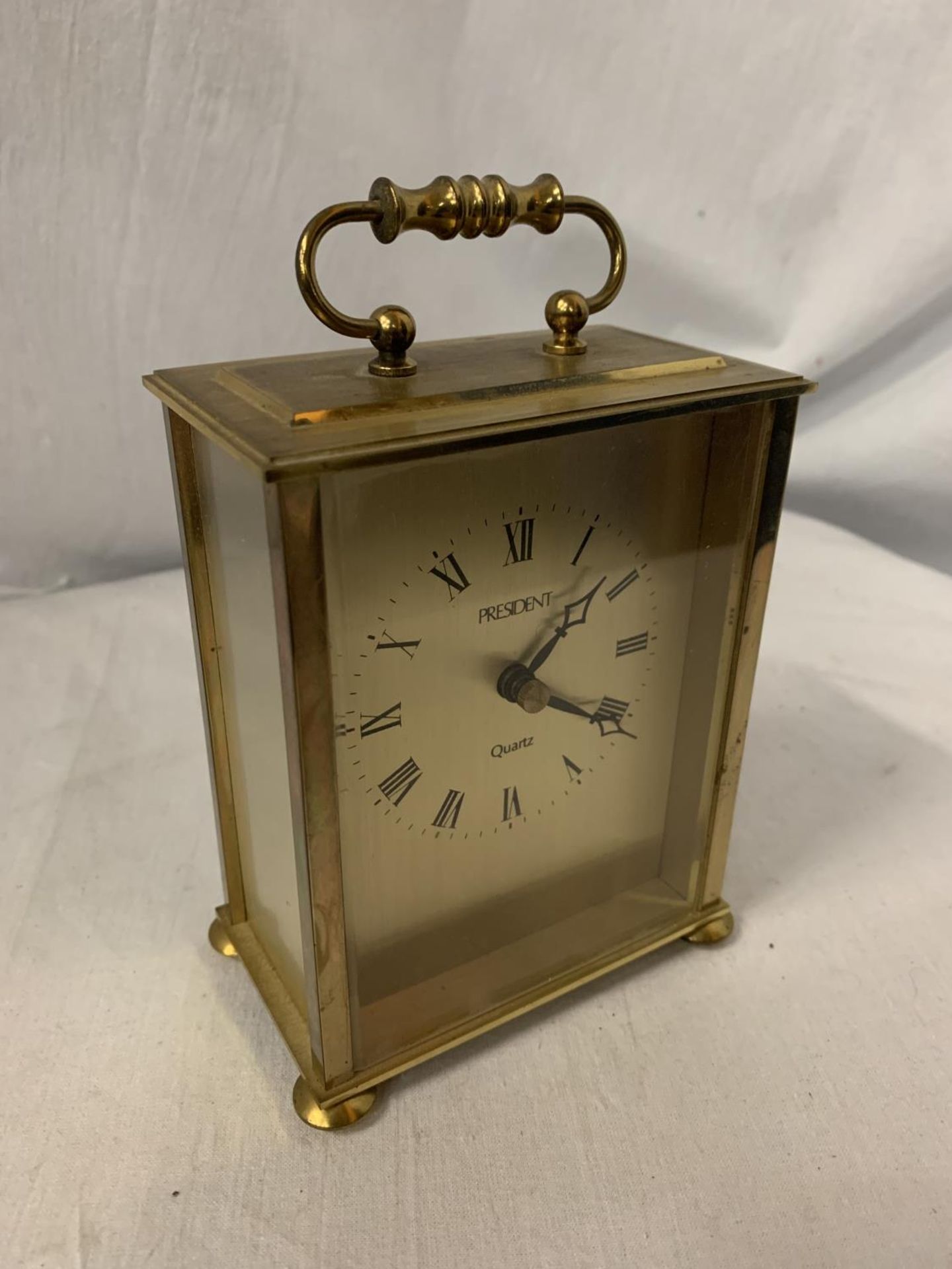 A QUARTZ PRESIDENT BRASS CARRIAGE CLOCK WITH INSCRIPTION ON THE BACK