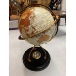 A DECORATIVE DESK GLOBE WITH BRASS DETAIL AND INTEGRATED COMPASS IN THE BASE H: APPROXIMATELY 31CM