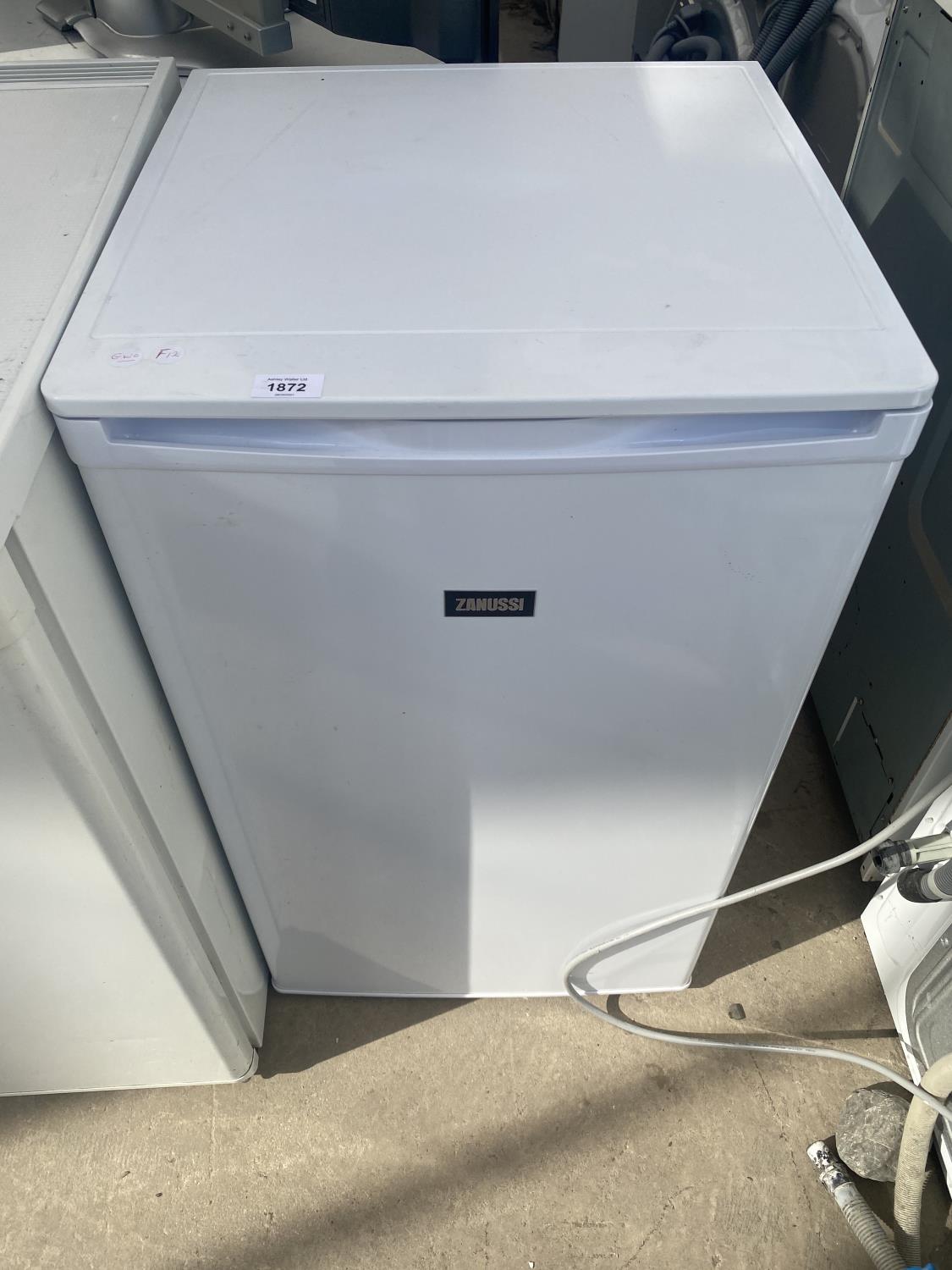 A WHITE ZANUSSI UNDER COUNTER FRIDGE BELIEVED IN WORKING ORDER BUT NO WARRANTY