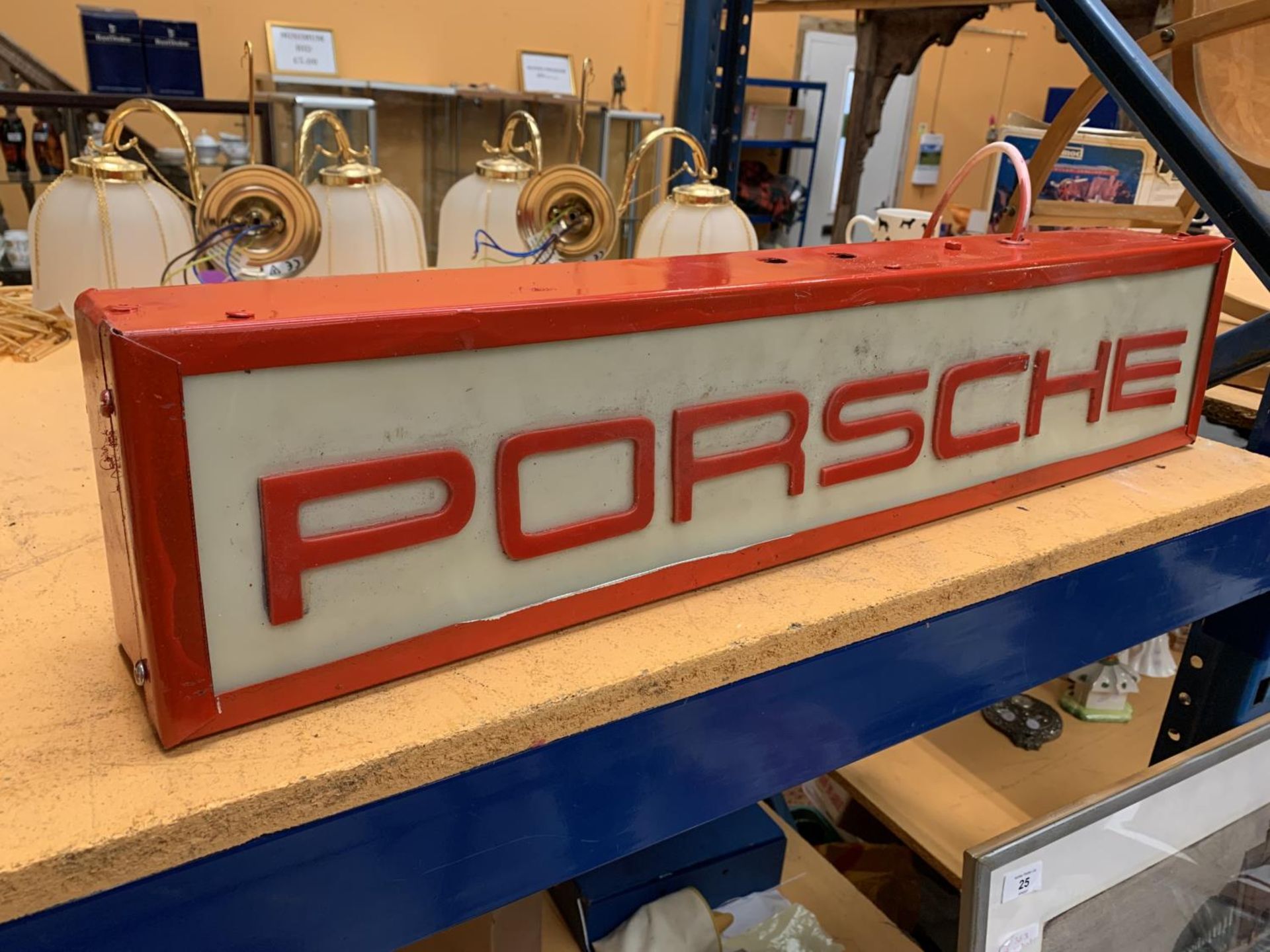 AN ILLUMINATED 'PORSCHE' SIGN