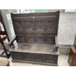 A VICTORIAN OAK SETTLE WITH TWELVE CARVED PANELS DEPICTING VARIOUS CRESTS AND MOTTO 'EAST, WEST,