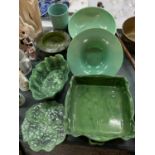 SEVEN ITEMS OF GREEN CERAMIC WARE TO INCLUDE A LARGE SERVING DISH AND A BOWL AND PLATTER IN THE FORM