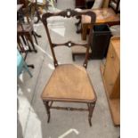 A VICTORIAN MAHOGANY BEDROOM CHAIR WITH FAUX SPLIT CANE SEAT AND BONE SHIELD APPLIED DECORATION