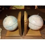 A PAIR OF BOOKENDS IN THE FORM OF GLOBES ON WOODEN PLINTHS