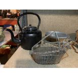 A LARGE BLACK ENAMEL KETTLE, A WHITE METAL WINE BASKET AND A FOOD WARMER
