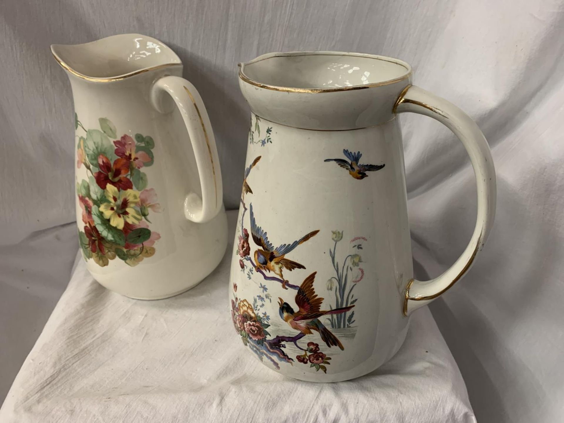 TWO LARGE CERAMIC JUGS ONE WITH FLORAL DECORATION, THE OTHER PEARL POTTERY WITH AVIAN DESIGN H: 31CM - Image 2 of 3