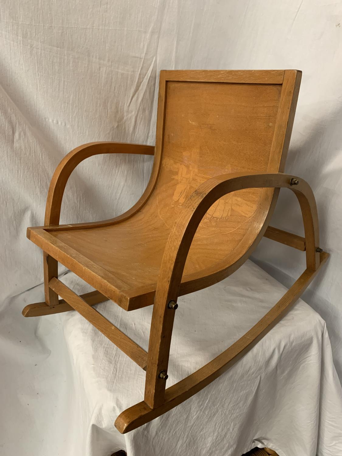 A CHILD'S WOODEN SCANDINAVIAN STYLE ROCKING CHAIR