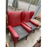 A PAIR OF RED LEATHERETTE PARKER KNOLL STYLE WINGED FIRESIDE CHAIRS
