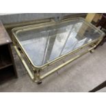 A MODERN BRASS FRAMED COFFEE TABLE WITH GLASS TOP, 54X24"