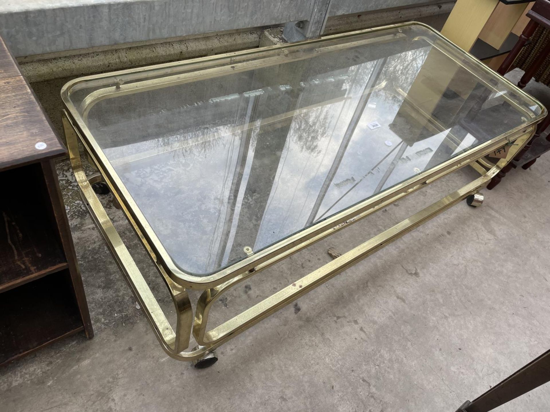 A MODERN BRASS FRAMED COFFEE TABLE WITH GLASS TOP, 54X24"