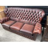 AN OXBLOOD 3 SEATER BUTTON BACK SETTEE