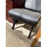 A BLACK LEATHER EFFECT FIRESIDE CHAIR