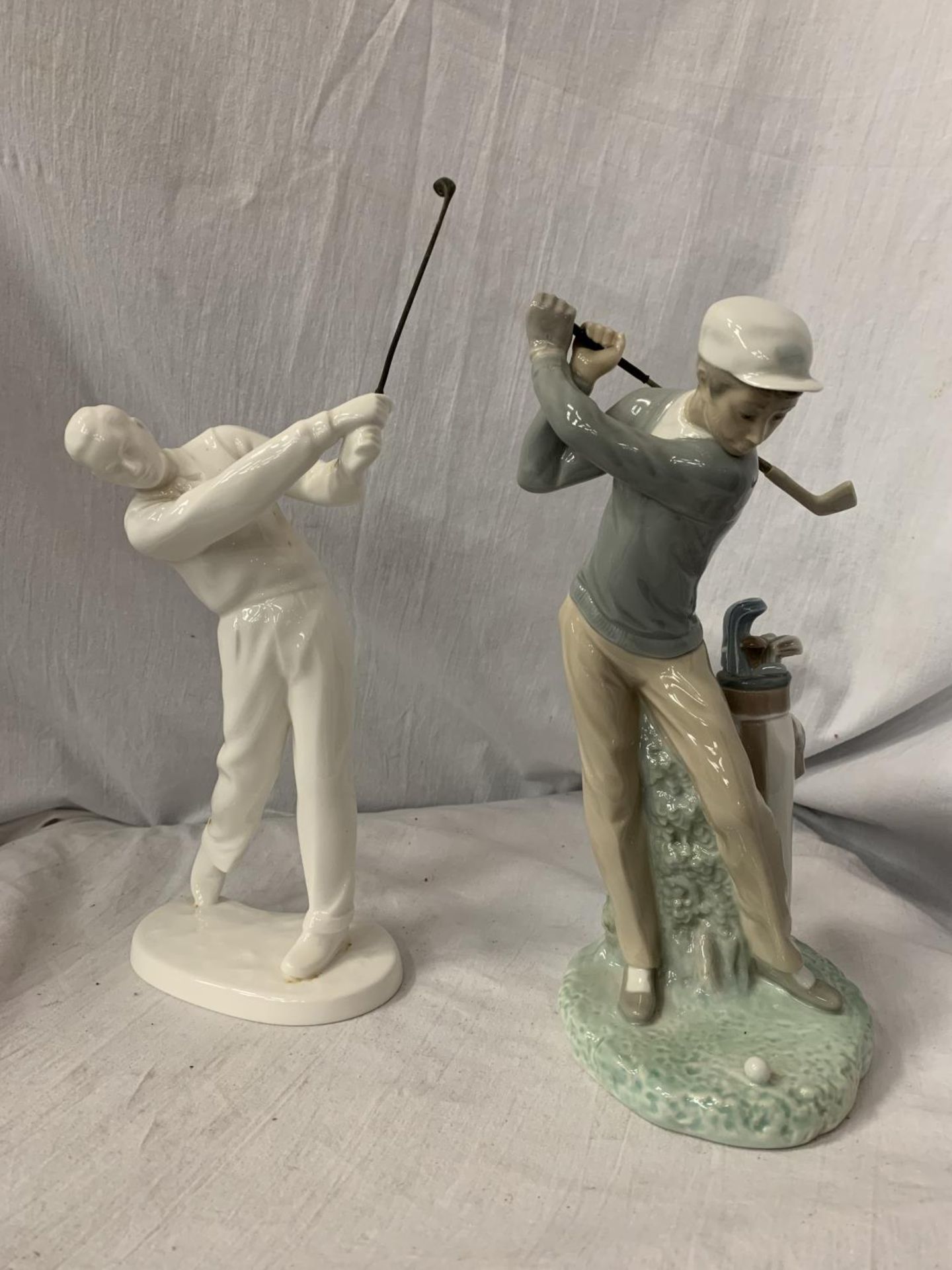 TWO GOLFING FIGURINES, ONE A NORITAKE EXAMPLE H:APPROXIMATELY 28CM