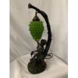 AN ORNATE VINTAGE COMPOSITE TABLE LAMP IN THE FORM OF A YOUNG CHILD AND A SHADE IN THE FORM OF A