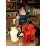 A LARGE GARDEN GNOME, TWO JULIANA MONEY BOXES, A JUG IN THE FORM OF A COW AND A STORAGE JAR IN THE