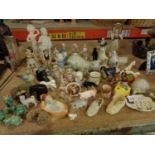 A LARGE ASSORTMENT OF FIGURINES IN THE FORM OF ANIMALS, BIRDS AND PEOPLE