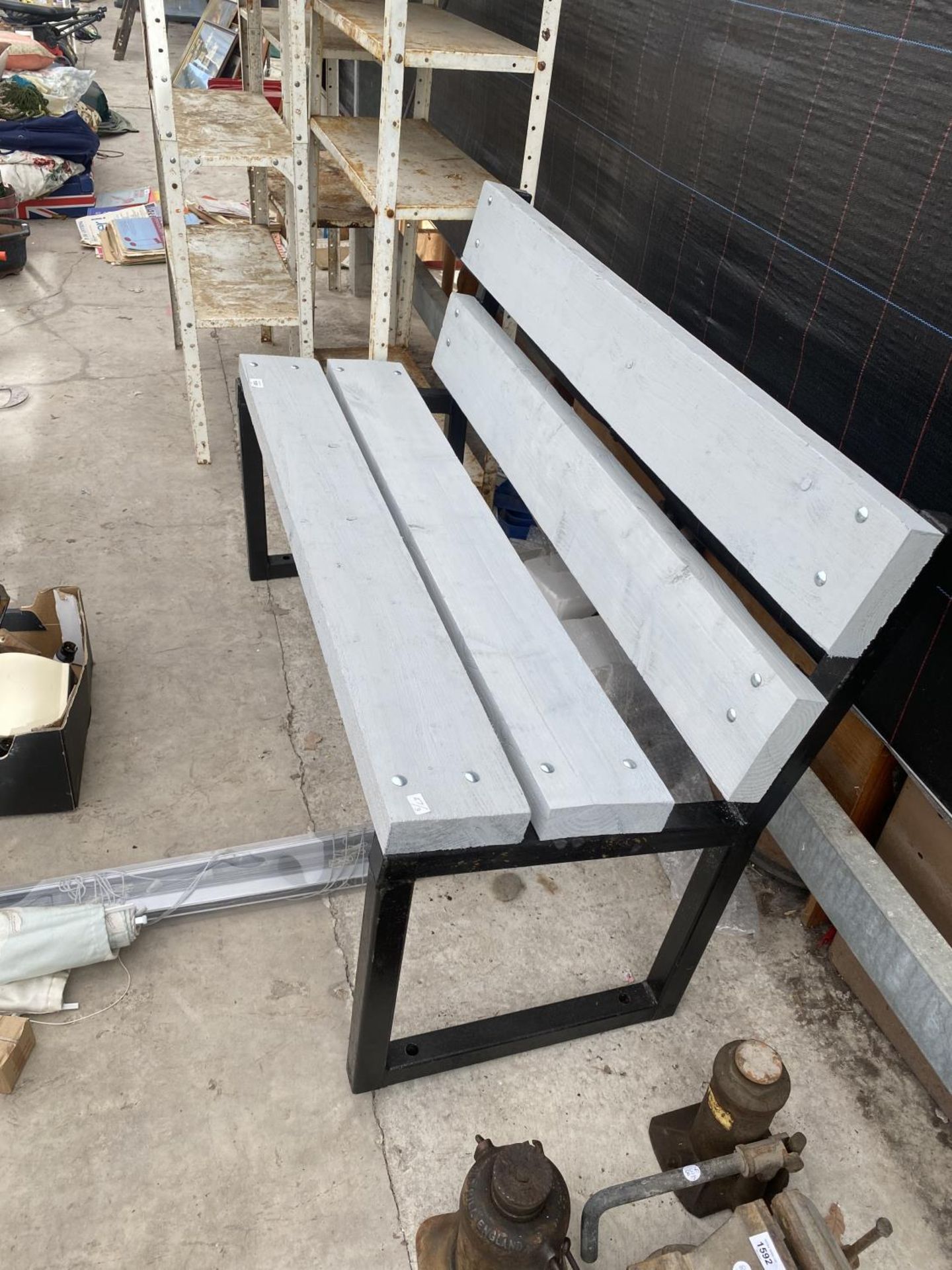 AN INDUSTRIAL STYLE WOODEN BENCH WITH METAL BENCH ENDS