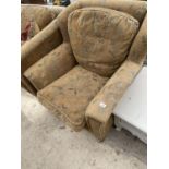 A VICTORIAN STYLE GREENSMITH SPRUNG AND UPHOLSTERED EASY CHAIR ON TURNED FRONT LEGS WITH BRASS