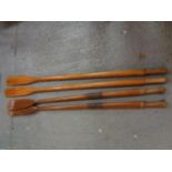 TWO PAIRS OF VINTAGE WOODEN OARS. ONE SET BEING 74" IN LENGTH AND THE OTHER 71"LONG