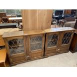 A PAIR OF PRIORY STYLE OAK GLAZED AND LEADED BOOKCASES 42" WIDE