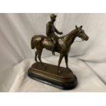 A SPELTER FIGURINE IN THE FORM OF A HORSE AND JOCKEY SIGNED C VALTON