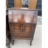 AN EARLY 20TH CENTURY OAK BUREAU, POSSIBLY AN OLD GRAMOPHONE CABINET W:25"