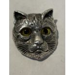 A STERLING SILVER BROOCH IN THE FORM OF A CAT WITH GLASS EYES