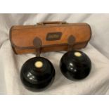 A LEATHER 'MITRE' CASE CONTAINING A PAIR OF BOWLS