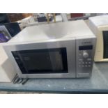 A SILVER BOSCH MICROWAVE OVEN BELIEVED IN WORKING ORDER BUT NO WARRANTY