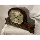 A NAPOLEON'S HAT MAHOGANY MANTEL CLOCK WITH OCTAGONAL FACE AND DECORATIVE EDGING