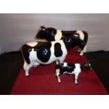 A BESWICK FRESIAN BULL, COW AND CALF