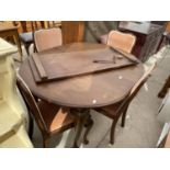 AN OVAL EDWARDIAN MAHOGANY WIND-OUT DINING TABLE WITH EXTRA LEAF, WINDER AND FOUR CHAIRS