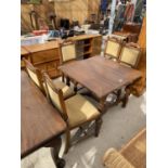 AN EARLY 20th CENTURY DINNER TABLE ON BARLEY TWIST LEGS (LACKING LEAVES) TO INCLUDE FOUR OAK