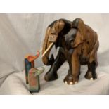 A LARGE CARVED HEAVY HARD WOOD ELEPHANT (H: APPROX. 30CM) AND TWO CERAMIC ELEPHANT ITEMS