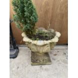 A DECORATIVE STONE EFFECT PLANTER IN THE FORM OF AN URN