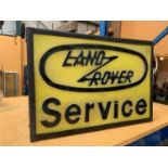 AN ILLUMINATED ' LAND ROVER SERVICE' SIGN