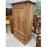 A MEXICAN PINE WARDROBE WITH TWO DOORS AND THREE LOWER DRAWERS