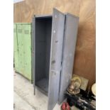 A LARGE METAL STORAGE CUPBOARD WITH INTERNAL SHELVES