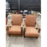 A PAIR OF EARLY 20TH CENTURY OAK FRAMED RECLINER CHAIRS WITH SWEPT ARM SUPPORTS AND BULBOUS UPRIGHTS