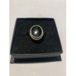 A SILVER AND JET RING IN A PRESENTATION BOX